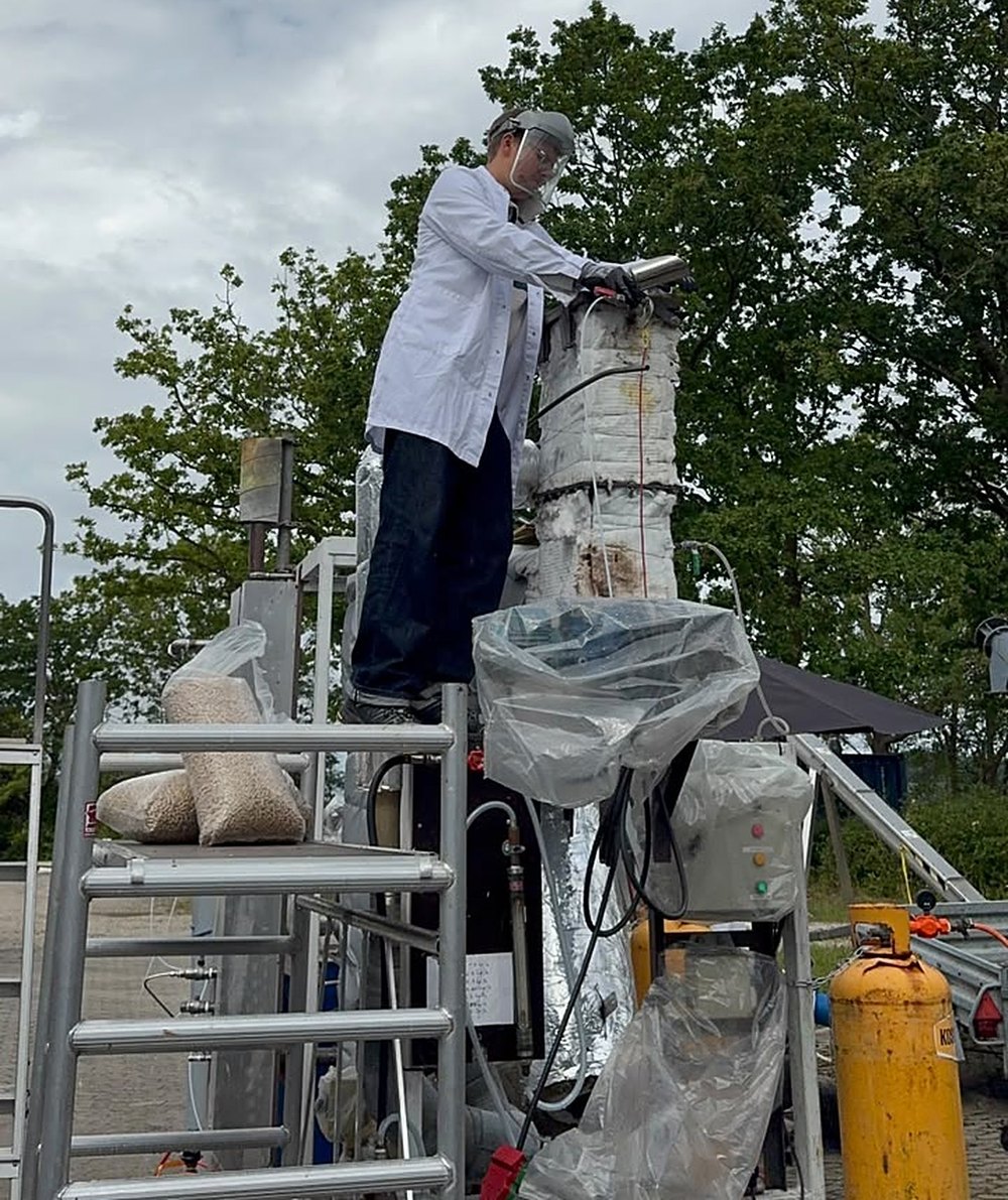 Johannes in a lab coat on the pilot-scale pyrolysis rig at DTU Risø